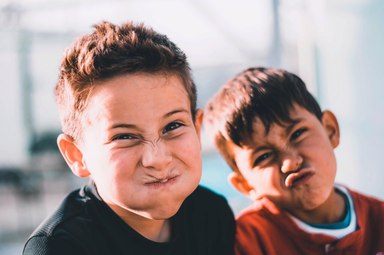 two school boys fooling aroung and making faces